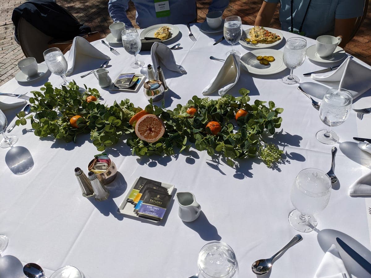 Outdoor cocktail reception under a tent with market string lights