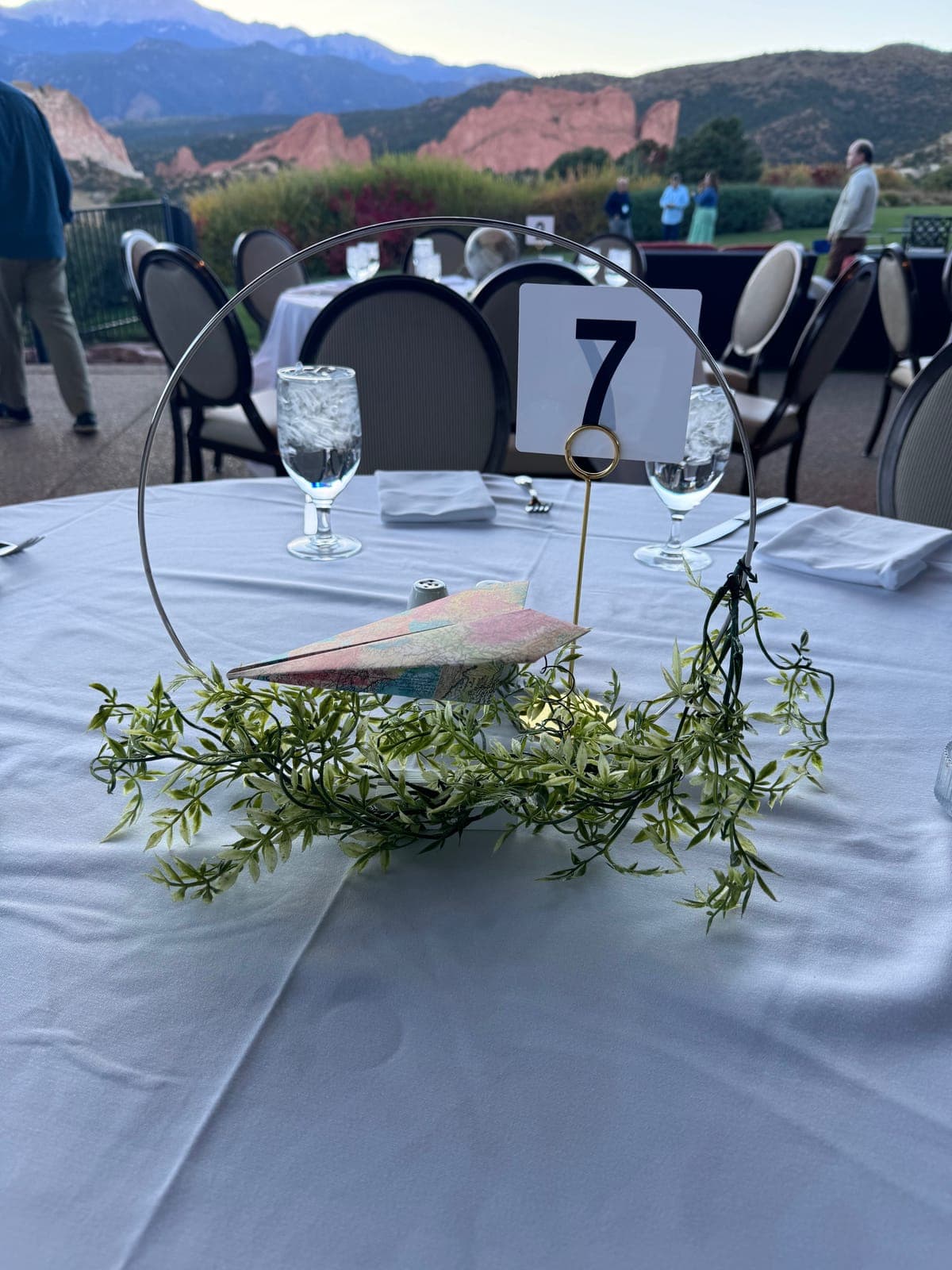 Formal dinner place settings with menu cards and gold flatware